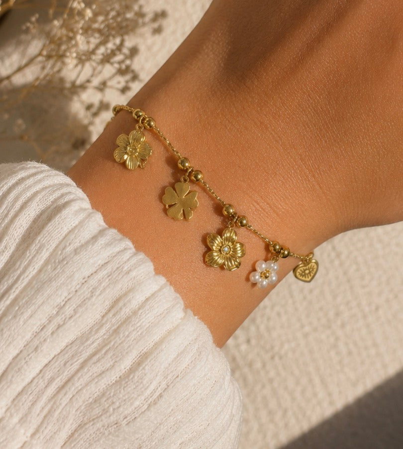 Bracelet doré à charms fleurs, trèfle et cœur œil rayonnant