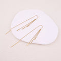 Boucles pendantes dorées - chaînes pendantes avec barres