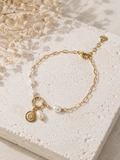 Bracelet doré chaîne et perles avec pendentif nautile